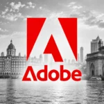 Čiernobiela panoráma Bombaja s Gateway of India a výrazným červeným logom Adobe v popredí.